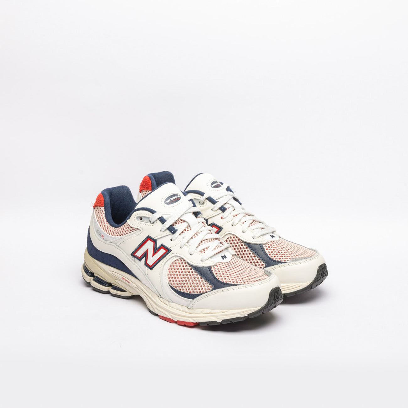 New Balance 2002 white leather running sneaker with blue and red details