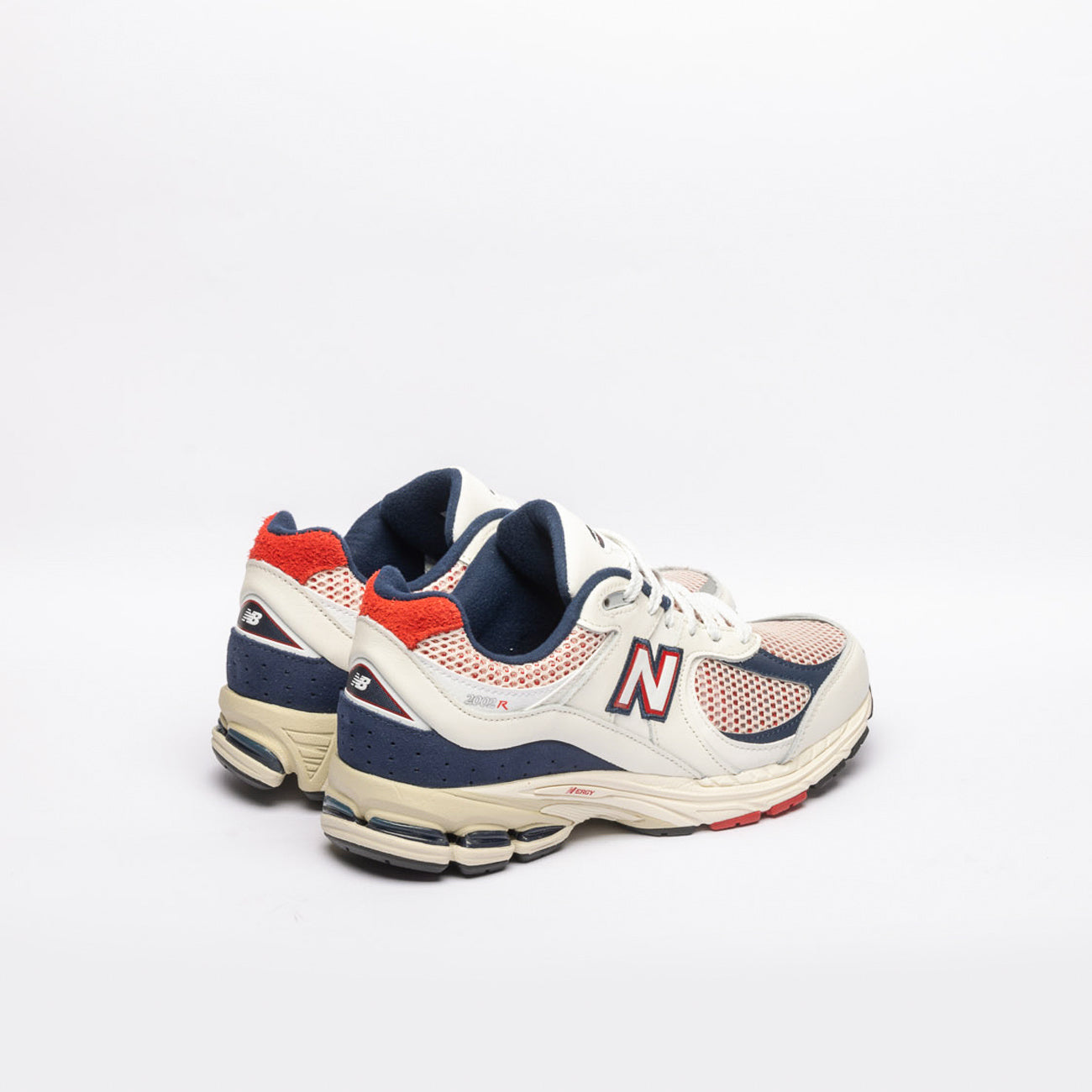 New Balance 2002 white leather running sneaker with blue and red details